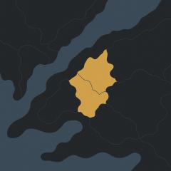 A dark map view showing a fictitious map with a water body, and a yellow region highlighted on the land.