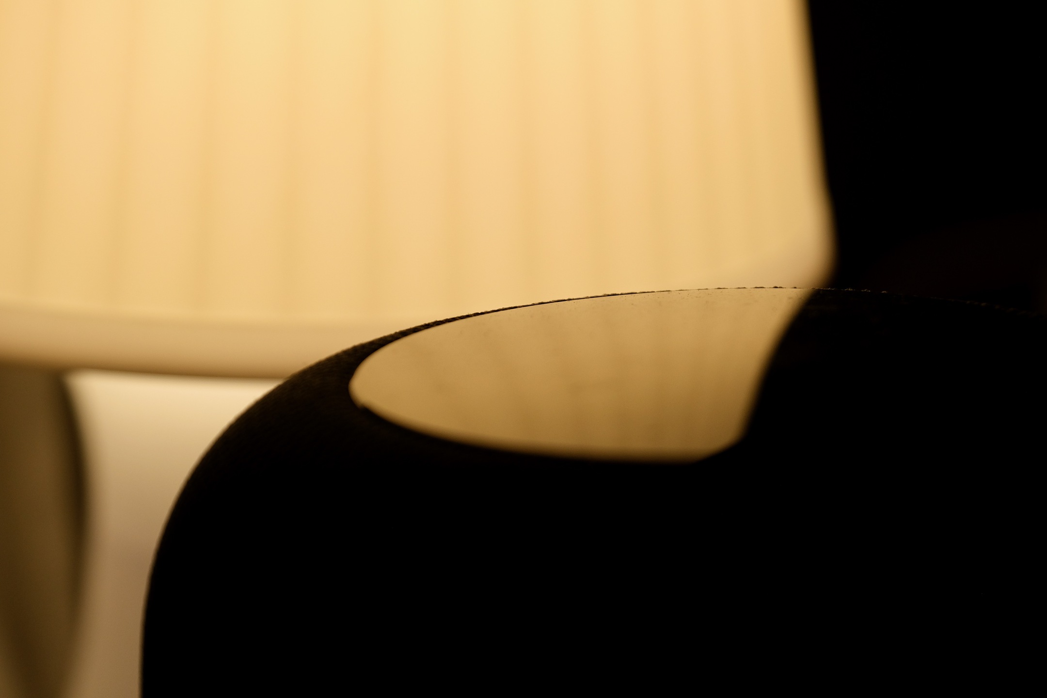 A cover image showing alight from a lamp reflecting off of a smooth surface.