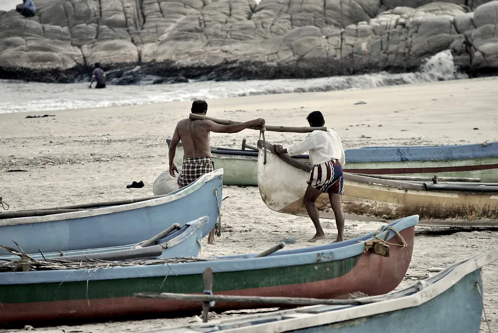 Two fishermen dragging the boat
